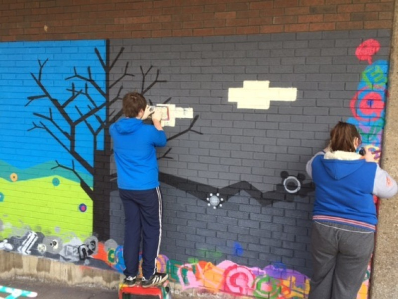Main image for Teens spray paint positive life choices mural