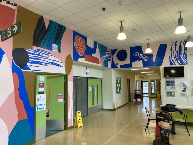 A COLOURFUL TRANSFORMATION: Professional artist Laura Slater has created a wall mural in the main entrance of the school.