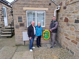 Volunteers Wayne Johnson, Glennis Charlesworth and Richard Ullyott at the new defibrillator on Field Lane.