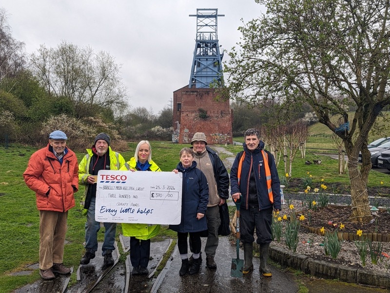Tesco community champion presenting £370 to the volunteers at Barnsley Main Heritage Group.