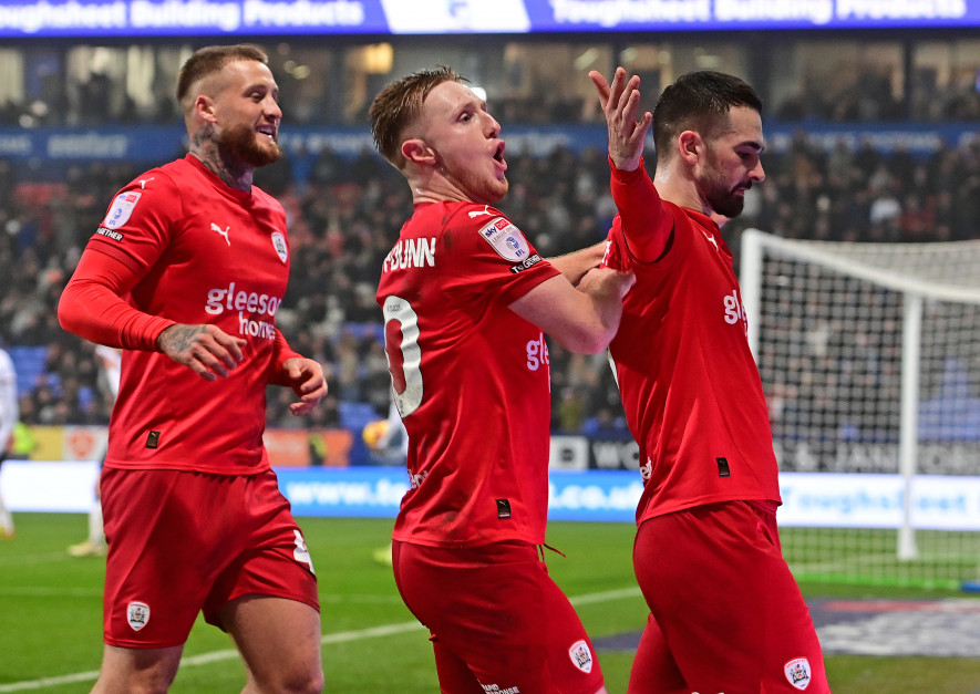 Away win: Barnsley celebrate Adam Phillips’ goal at Bolton.