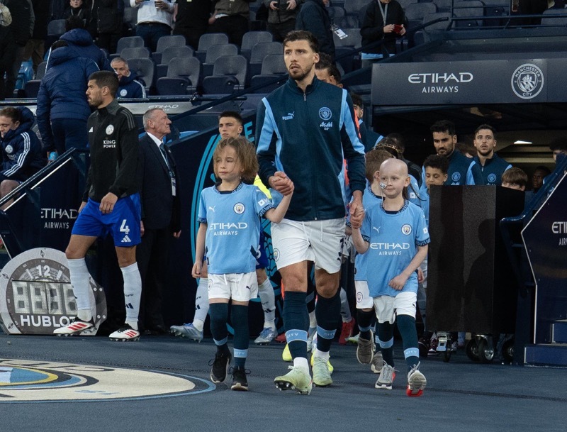 PROUD MOMENT: Oliver walks out with Manchester City’s captain, Ruben Dias.