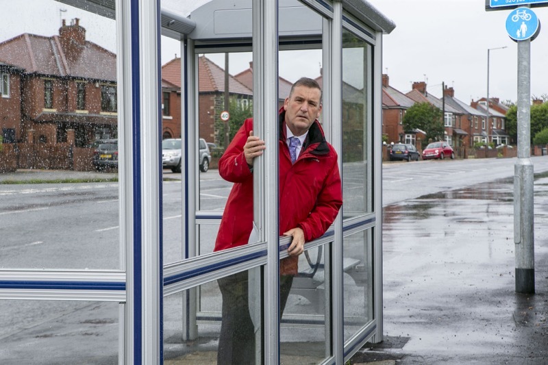 Shelter Damage: Coun Kevin Osbourne at the bus shelter in Darfield, which repeatedly has the glass panels smashed. Picture Shaun Colborn PD092419