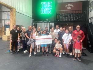 BOX-ING CLEVER: Harley Stringer, centre, with his cheque for Barnsley Hospital Charity surrounded by members and supporters at The Box Gym.