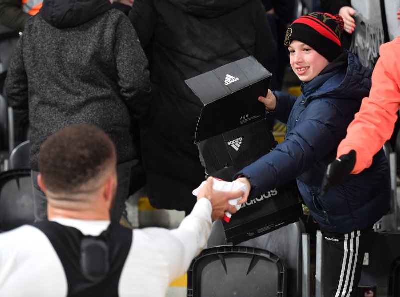 Carlton Morris gives his shirt to a young fan on Tuesday