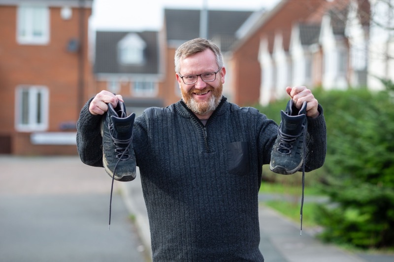 ONE BIG STEP: Gareth Roebuck and the boots that challenged him to 15,000 steps everyday. Picture Shaun Colborn PD092884