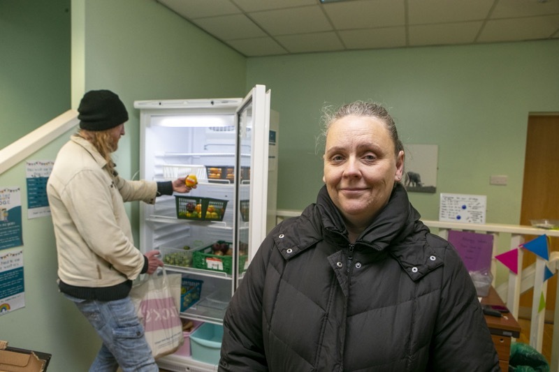 Main image for Community fridge volunteers encouraging residents to use it