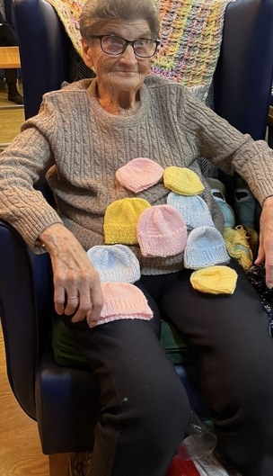 Margaret Binns, with her knitted hats for Barnsley Hospitals neonatal unit.