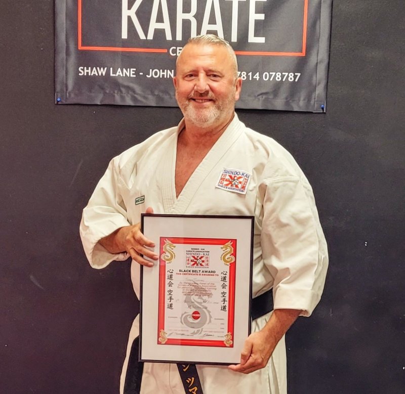 Main image for Karate coach John given 8th dan belt on birthday