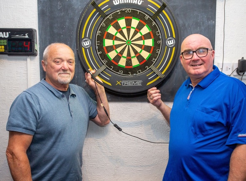 BIG HEARTS: Dick Ormrod and Paul Bates are two of the driving forces behind a darts league that has raised nearly £90,000 over the last 15 years to donate to charities. Picture Shaun Colborn PD094274