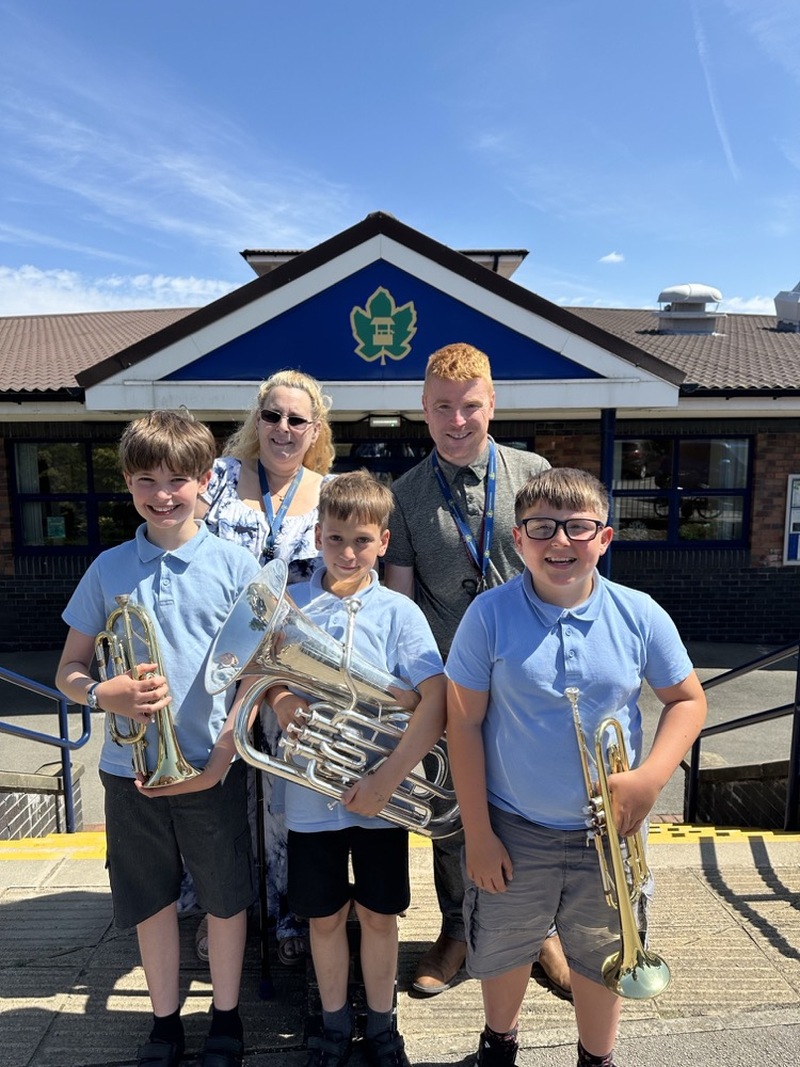 PRAISED: Pupils Arran Clarke, Nikita Wellings and Harrison Griffiths with staff Susan Sharpe and James Roberts.