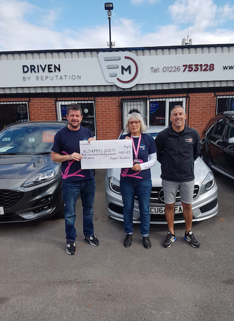 CHEQUE: Robert Blackburn, left, presents the fruits of his swim to the Alzheimer’s Society.