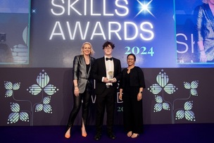 STUDENT OF THE YEAR: Elliot Barton collects the T Level Student of the Year Award from Tania Gandamihardja, Group Human Resources Director at BAE Systems (right) and Honorary Fellow of the Royal Academy of Engineering and award-winning broadcaster Steph McGovern (left).