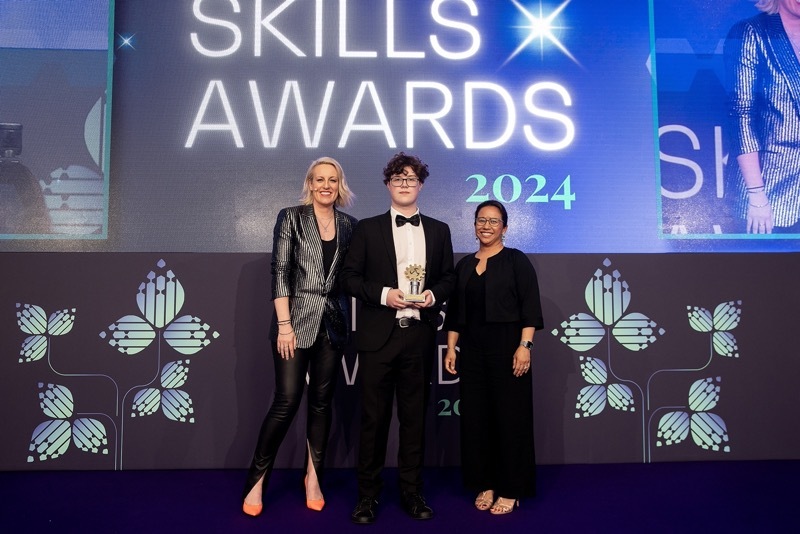 STUDENT OF THE YEAR: Elliot Barton collects the T Level Student of the Year Award from Tania Gandamihardja, Group Human Resources Director at BAE Systems (right) and Honorary Fellow of the Royal Academy of Engineering and award-winning broadcaster Steph McGovern (left).