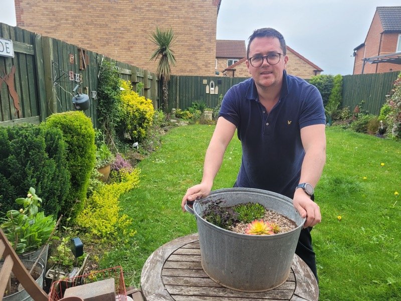Ashley Ball at work in his garden.