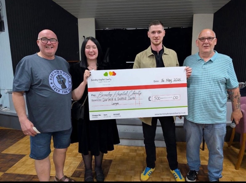 ON POINT: Darts league members present the cheque to Jane Mills from Barnsley Hospital Charity.