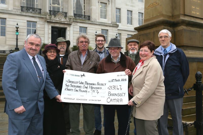 Main image for War memorial restoration volunteers smile for CAMRA