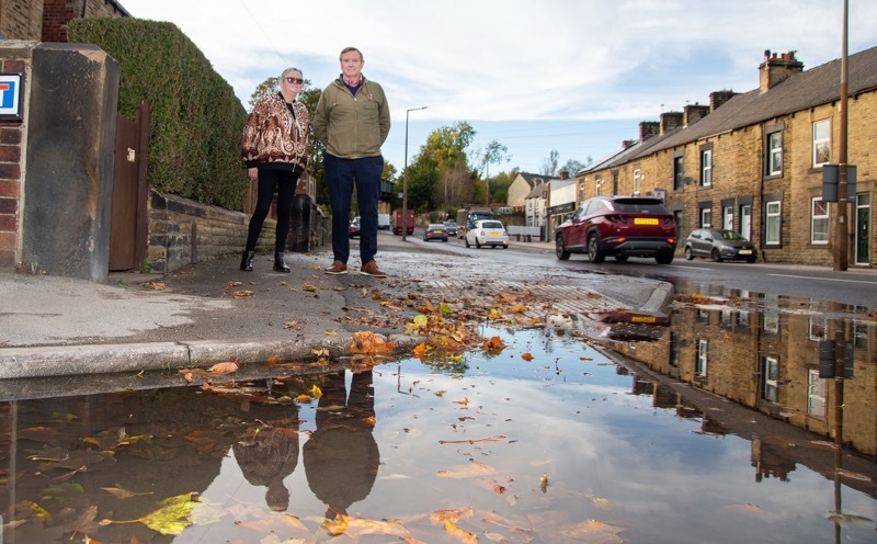 LEAKY ROAD: Coun Shirt and Coun Dyson survey the leak on Doncaster road. Picture Shaun Colborn PD094597