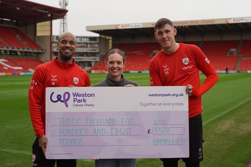 TAKEOVER: David McGoldrick and Kieren Flavell hand over the cheque.