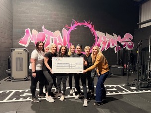 Members of Motiv Fiitness, holding the cheque.