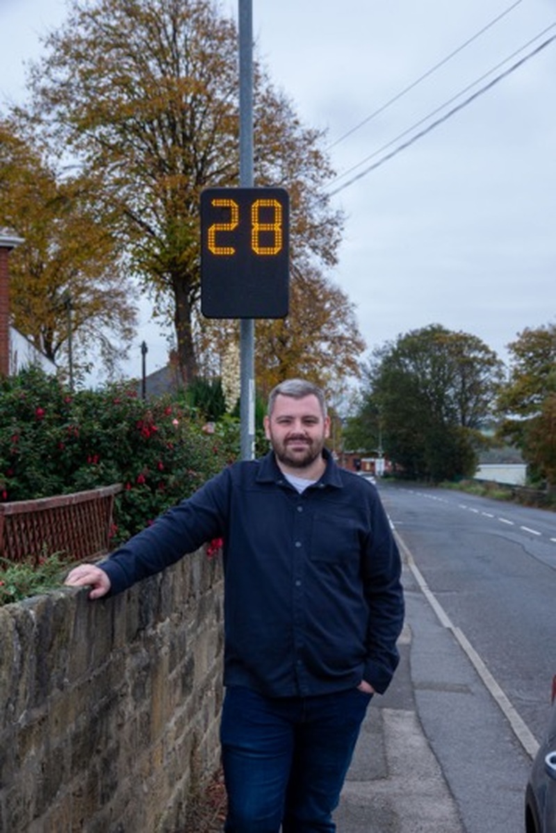 Coun Jake Lodge with one of the functioning speed awareness indicators on Genn Lane. Picture Shaun Colborn PD094557
